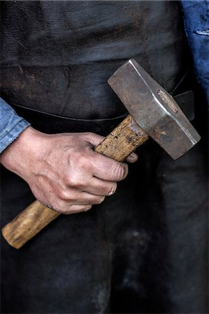 dirt worker - Hand with hammer Stock Photo - Premium Royalty-Free, Code: 6102-08329667