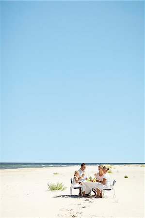 simsearch:6102-08329928,k - Family having meal on beach Photographie de stock - Premium Libres de Droits, Code: 6102-08329677