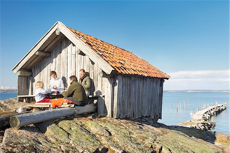 Family near wooden building at sea Stock Photo - Premium Royalty-Free, Code: 6102-08329758