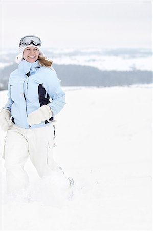 simsearch:6102-08329857,k - Smiling woman running in winter landscape Stock Photo - Premium Royalty-Free, Code: 6102-08329829