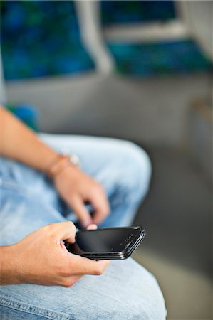 public transit - Teenager holding cell phone Stock Photo - Premium Royalty-Free, Code: 6102-08329939