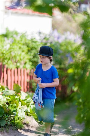 Boy exploring garden Stock Photo - Premium Royalty-Free, Code: 6102-08481458