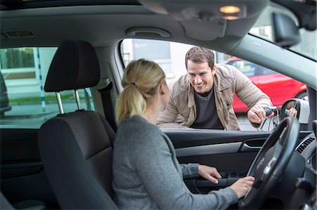 Man talking to woman while she is driving car Stock Photo - Premium Royalty-Free, Code: 6102-08481485