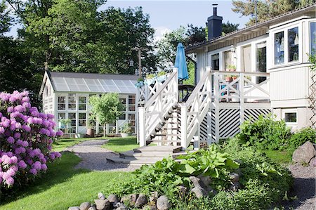 europe house with garden - Exterior of weekend cottage and greenhouse Stock Photo - Premium Royalty-Free, Code: 6102-08481574
