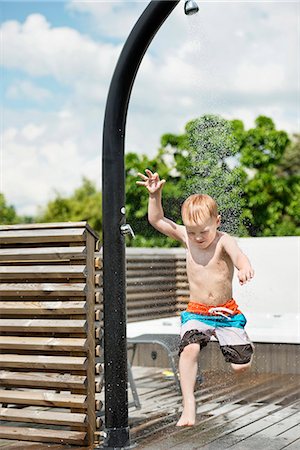 family jump into swimming pool images - Boy having shower in garden Stock Photo - Premium Royalty-Free, Code: 6102-08481524