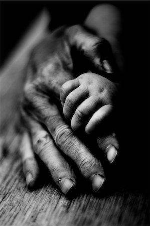 father and son black and white - Three people holding hands together Stock Photo - Premium Royalty-Free, Code: 6102-08542242