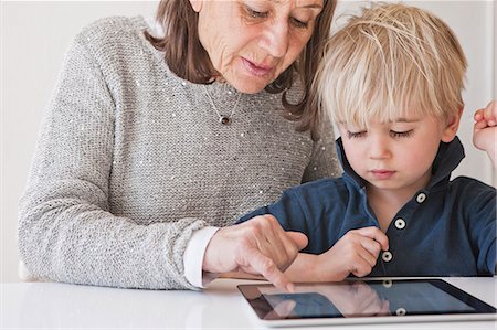 simsearch:6102-08566169,k - Grandmother with grandson using digital tablet Stock Photo - Premium Royalty-Free, Code: 6102-08559264