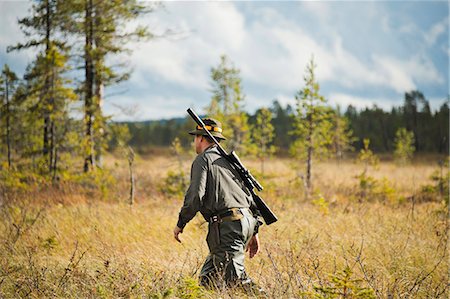 person with a rifle - Hunter at hunting Stock Photo - Premium Royalty-Free, Code: 6102-08559219