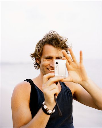 simsearch:6102-03905685,k - A man using a camera. Stock Photo - Premium Royalty-Free, Code: 6102-08559499