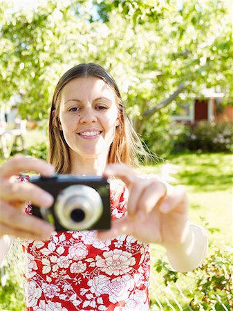 simsearch:6102-03865784,k - A woman taking a picture, Sweden. Stockbilder - Premium RF Lizenzfrei, Bildnummer: 6102-08559433