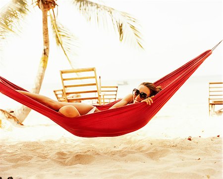 A woman in a hammock. Stock Photo - Premium Royalty-Free, Code: 6102-08559510