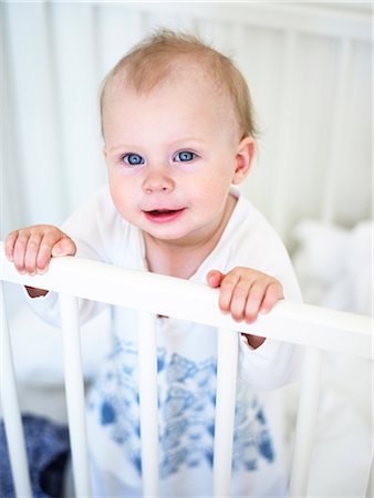 simsearch:6102-08542337,k - Baby standing in a cot, Sweden. Stockbilder - Premium RF Lizenzfrei, Bildnummer: 6102-08559525