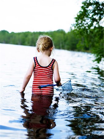Scandinavia, Sweden, Girl (4-5) fishing in lake, rear view Stock Photo - Premium Royalty-Free, Code: 6102-08566037