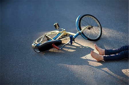 simsearch:6109-08830432,k - Child with bicycle fallen on street Photographie de stock - Premium Libres de Droits, Code: 6102-08566159