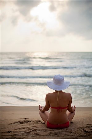 simsearch:6102-08996069,k - Woman meditating on beach Stock Photo - Premium Royalty-Free, Code: 6102-08566206