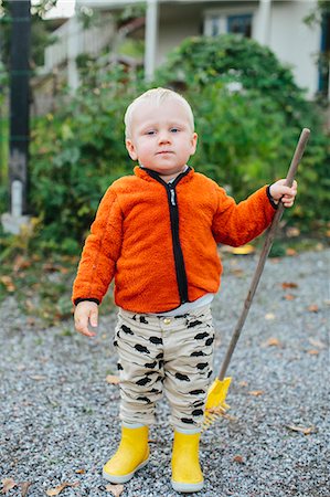 fall imagery rainboots - Boy with rake Stock Photo - Premium Royalty-Free, Code: 6102-08566497