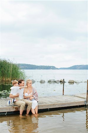 father and newborn - Family sitting on jetty Stock Photo - Premium Royalty-Free, Code: 6102-08566499