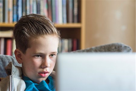 Boy using laptop Stock Photo - Premium Royalty-Free, Code: 6102-08566637