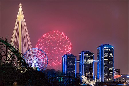 fireworks at funfair - Fireworks display and illuminated buildings Stock Photo - Premium Royalty-Free, Code: 6102-08566762