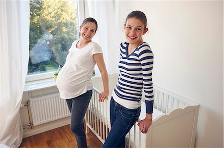 pregnant mom - Mother with daughter standing near cot Stock Photo - Premium Royalty-Free, Code: 6102-08566776