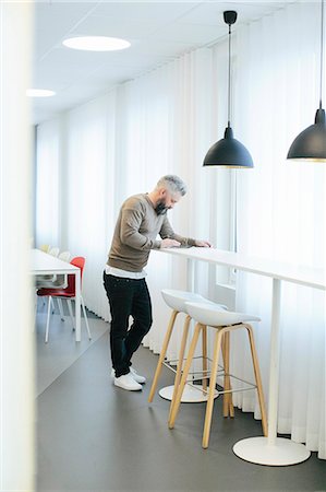 pic of a lonely person standing alone - Man using digital tablet Stock Photo - Premium Royalty-Free, Code: 6102-08566835