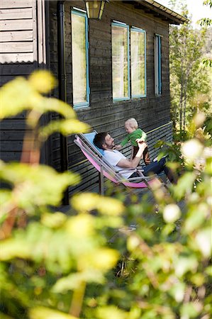 father and child in a sun chair Foto de stock - Sin royalties Premium, Código: 6102-08520459