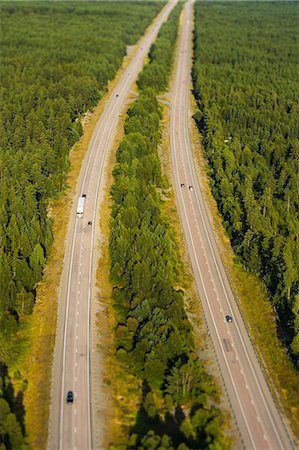 simsearch:6102-08520618,k - Aerial view of country road through forest Stock Photo - Premium Royalty-Free, Code: 6102-08520638