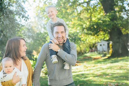 female mischievous grin - Family with two children in park Stock Photo - Premium Royalty-Free, Code: 6102-08520743