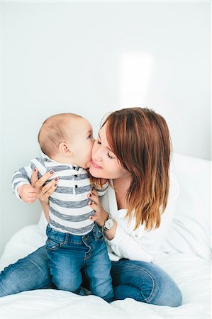 Mother with baby boy playing in bedroom Stock Photo - Premium Royalty-Free, Code: 6102-08520805