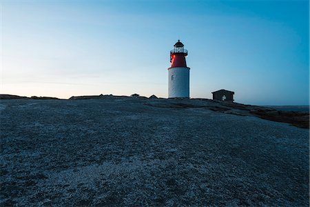 simsearch:6102-08000559,k - Lighthouse on rock against blue sky Stock Photo - Premium Royalty-Free, Code: 6102-08520830