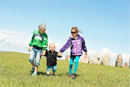 simsearch:6102-08270736,k - Brother and sister walking with baby boy brother Foto de stock - Royalty Free Premium, Número: 6102-08520929