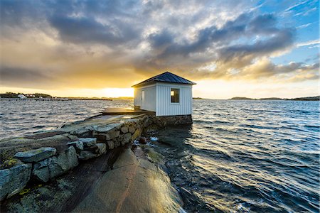 dock and water - Wooden building on stone jetty Stock Photo - Premium Royalty-Free, Code: 6102-08521140