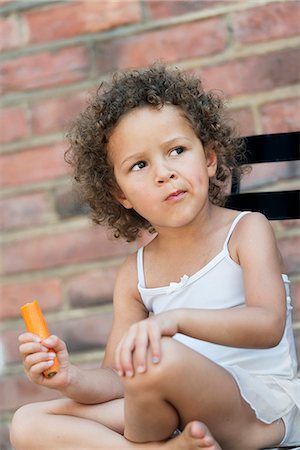 simsearch:6102-08952062,k - Girl eating carrot outside building Stock Photo - Premium Royalty-Free, Code: 6102-08683170