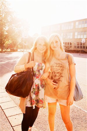 Teenage girls standing on schoolyard Stock Photo - Premium Royalty-Free, Code: 6102-08746078