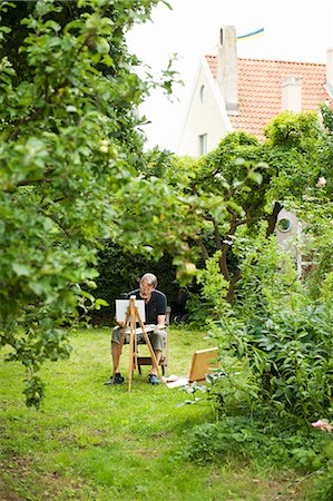 people at house backyard - Man painting in his back yard Stock Photo - Premium Royalty-Free, Code: 6102-08746130