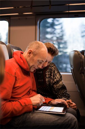 simsearch:6102-07843643,k - Man and teenage boy using tablet on train Photographie de stock - Premium Libres de Droits, Code: 6102-08746276
