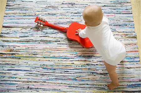 Baby boy with toy guitar Stock Photo - Premium Royalty-Free, Code: 6102-08746229