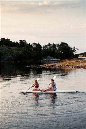 simsearch:6102-08542446,k - Two sisters kayaking Stock Photo - Premium Royalty-Free, Code: 6102-08746560