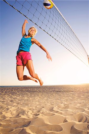 Young woman playing beach volleyball Fotografie stock - Premium Royalty-Free, Codice: 6102-08746515