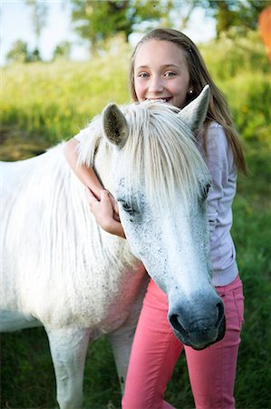 simsearch:6102-08746672,k - Smiling girl with horse Photographie de stock - Premium Libres de Droits, Code: 6102-08746673