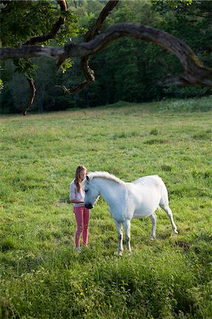 simsearch:6102-08746672,k - Smiling girl with horse Photographie de stock - Premium Libres de Droits, Code: 6102-08746672