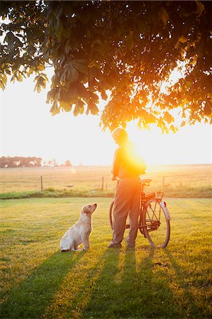 picture of old man on a bike - Senior man with dog Stock Photo - Premium Royalty-Free, Code: 6102-08746608