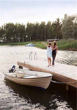 scandinavia lake friends - Two girls walking on jetty Stock Photo - Premium Royalty-Free, Code: 6102-08746638