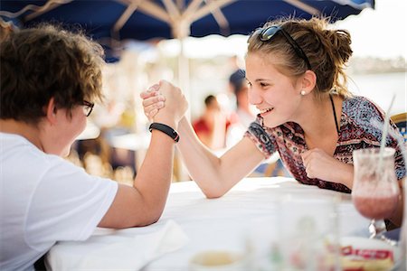 Brother and sister arm wrestling Stock Photo - Premium Royalty-Free, Code: 6102-08746796