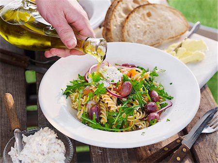 Pouring olive over pasta meal Fotografie stock - Premium Royalty-Free, Codice: 6102-08746949