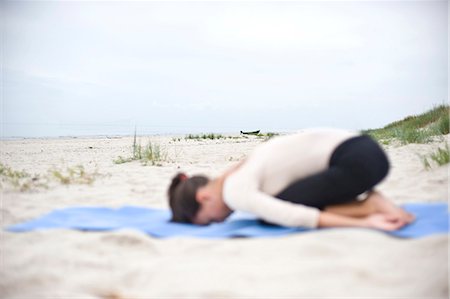 simsearch:6102-08683485,k - Young woman doing yoga on beach Stock Photo - Premium Royalty-Free, Code: 6102-08746907