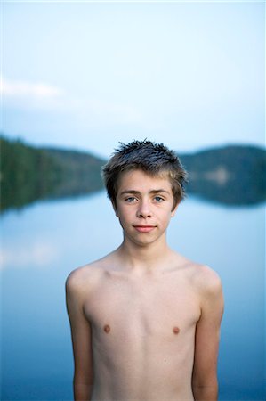 Portrait of teenage boy by lake Stock Photo - Premium Royalty-Free, Code: 6102-08748469