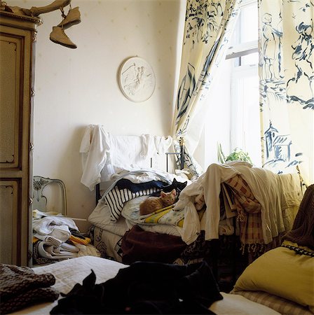 Two cats lying on bed in messy room Photographie de stock - Premium Libres de Droits, Code: 6102-08748473