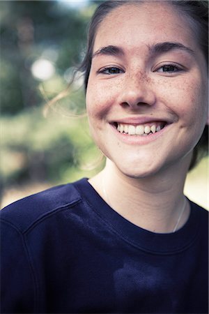 simsearch:6102-04929804,k - Portrait of teenage girl smiling outdoors Stock Photo - Premium Royalty-Free, Code: 6102-08748537