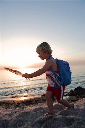 Girl with feather running on beach Stock Photo - Premium Royalty-Free, Code: 6102-08748649